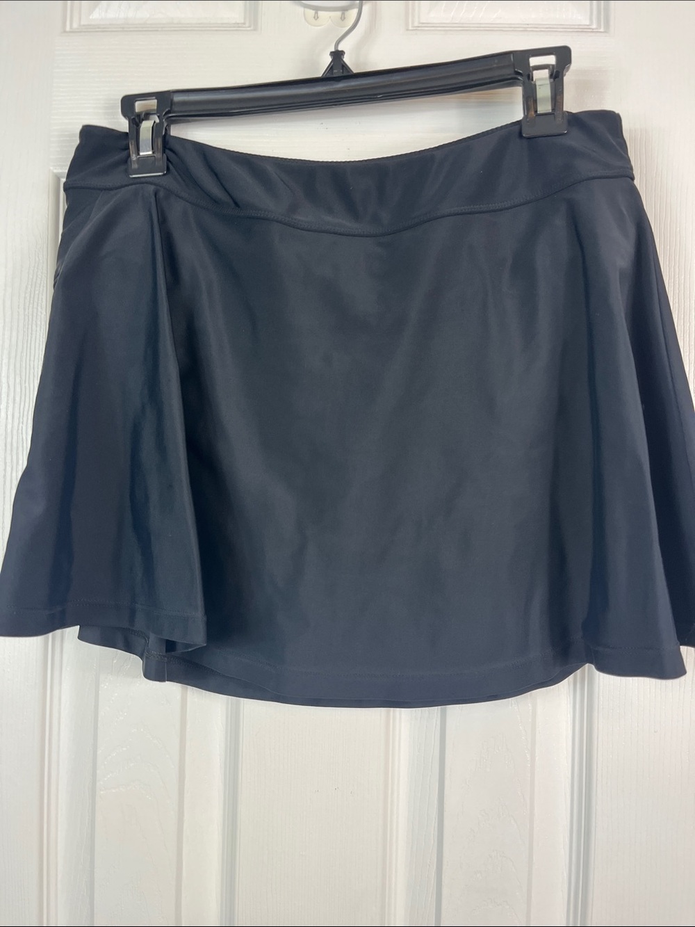 Black skirt swim bottom waist 14”. Zip pocket on sides. Elastic waistband